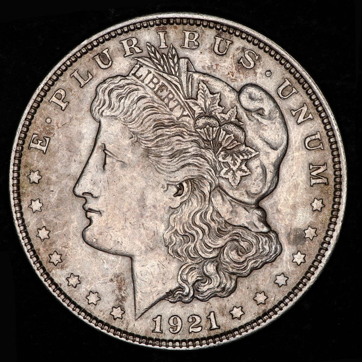 A 1921 Morgan silver dollar, obverse: Liberty facing left, the date 1921 below